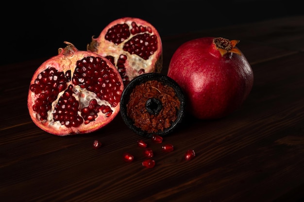 A hookah smoking bowl filled with red pomegranate flavor tobacco