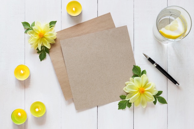 Horizontal photo of blank Sheet of paper with a pen and candles on wooden background