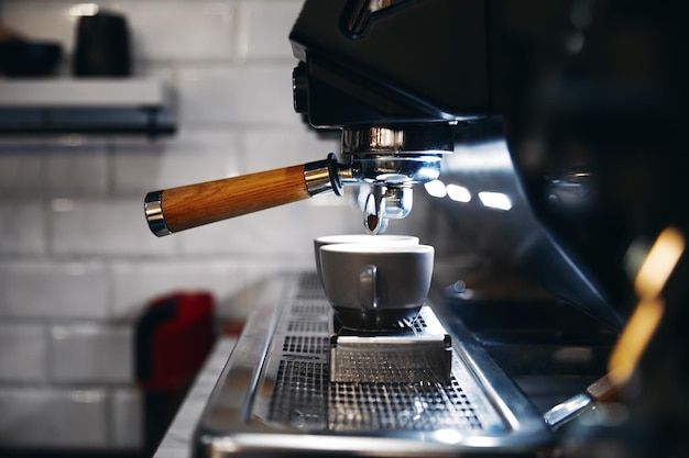 Horizontal photo of espresso machine working with bar interior background