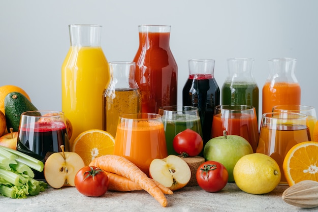 Horizontal shot of squeezed vegetables and fruits in glass bottles. 