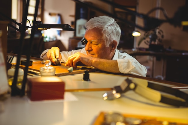 Horologist repairing a watch