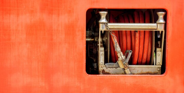 Hoses to quench the fire and fire rolling extinguisher in fire truck.