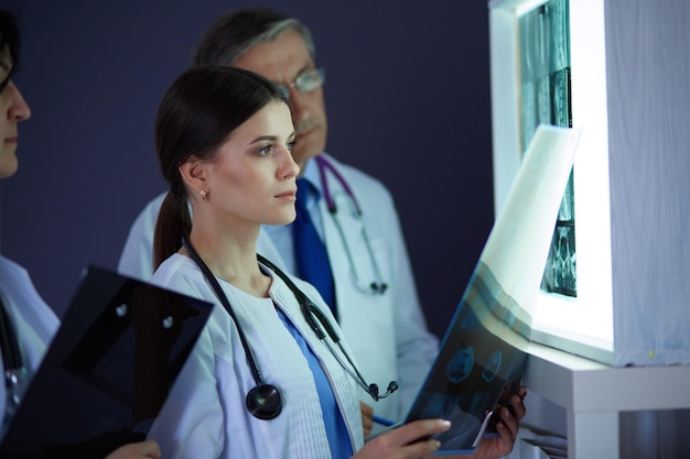 Hospital doctors looking at xrays in an emergency room