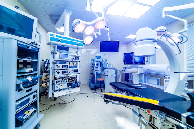 Hospital interior with operating surgery table lamps and ultra modern devices technology in modern clinic