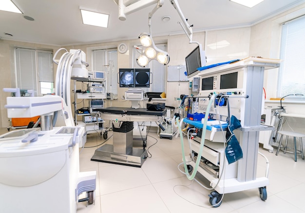 Hospital interior with operating surgery table, lamps and ultra modern devices, technology in modern clinic