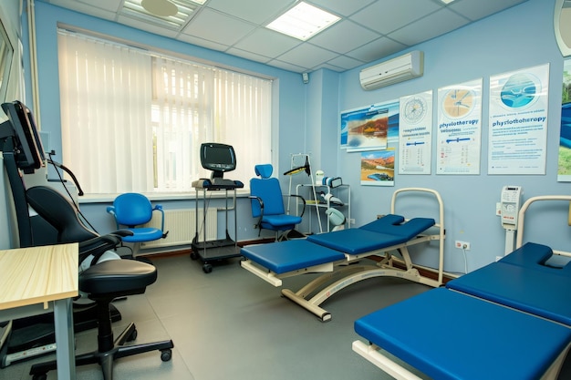 A hospital room adorned with serene blue chairs and stateoftheart medical equipment creating an atmosphere of peace and comfort