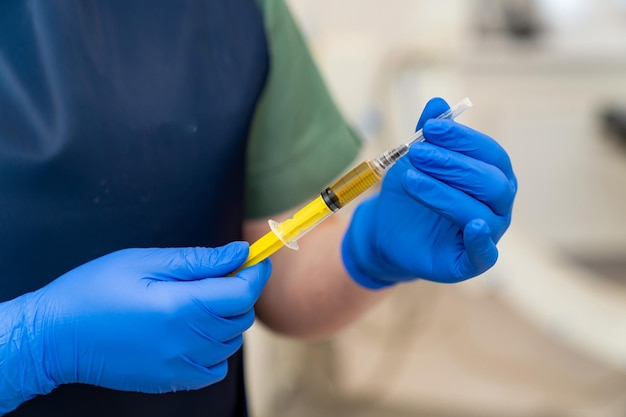 Hospital syringe laboratory researching Injection prepairing in gloved hands