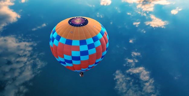 Hot air balloon over the blue sea View from above