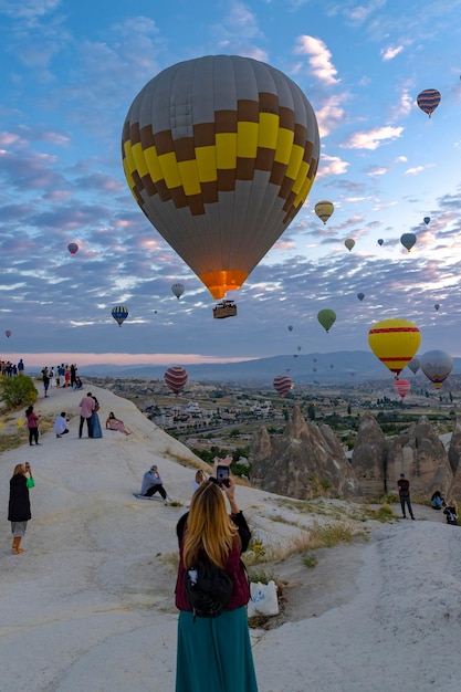 Hot air balloon flies near the tourists