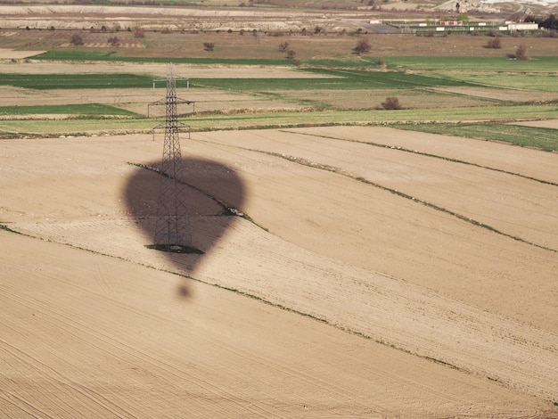 Hot air balloon shadow flying over the landscape at Cappadocia