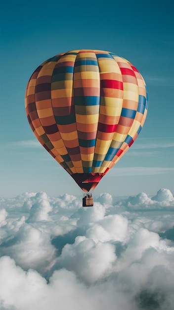 Hot air balloon with multicolored pattern floats above clouds