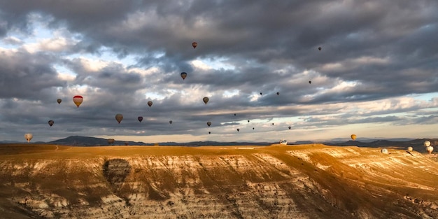 Hot air balloons in flight at dawn near goreme