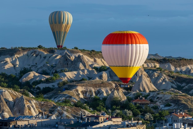 Hot air balloons fly over the city of goreme