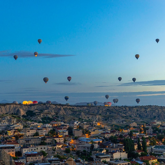 Hot air balloons fly at sunrise