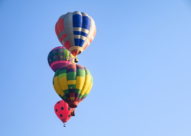 Hot air balloons flying on blue sky