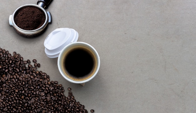 Hot americano and coffee bean on cement table 