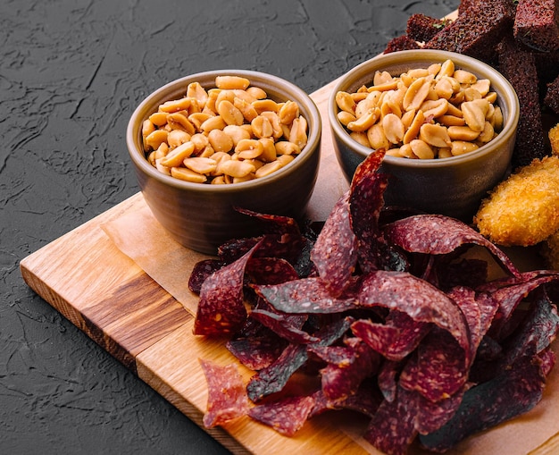 Hot appetizer on wooden tray for beer