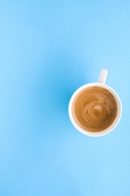 Hot aromatic coffee on blue background flatlay