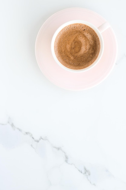 Hot aromatic coffee on marble flatlay