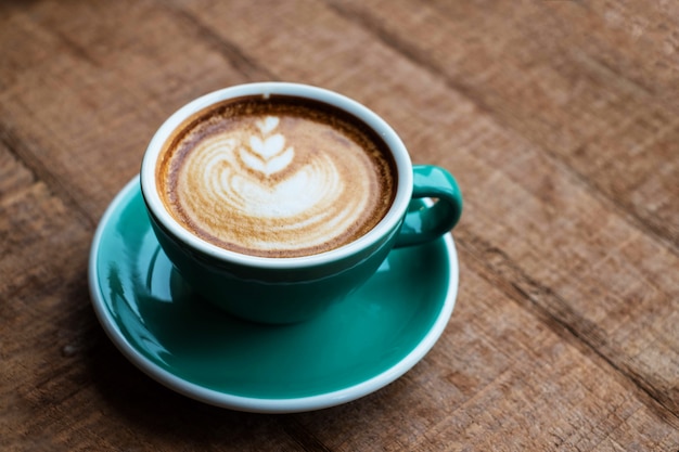 Hot art latte coffee on wood table