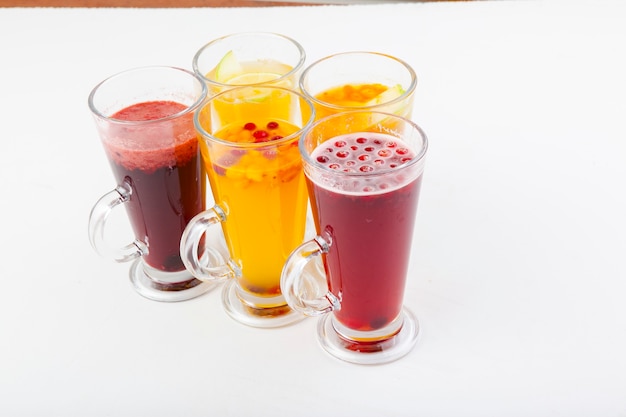 hot berry drinks in a glass glass on a white background