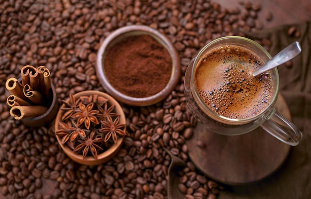 Hot black coffee and coffee beans on the old wooden table