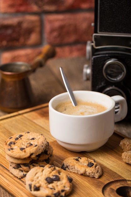 Hot black coffee with cookies and beans in cafe