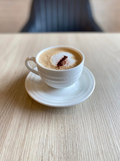 Hot cappuccino cup on table