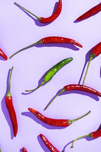 Hot chili peppers on colorful backgrounds