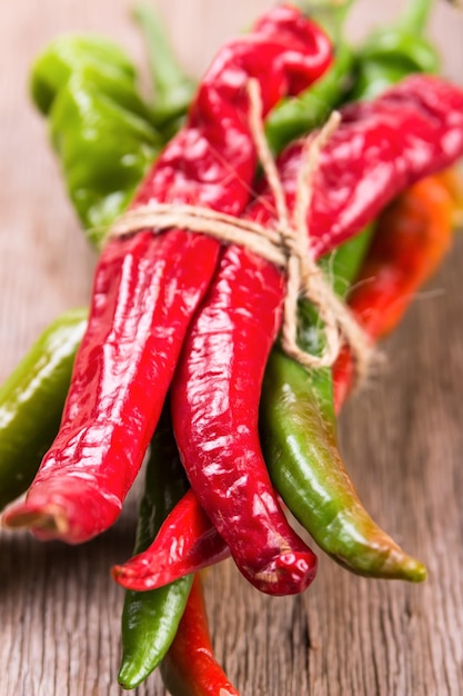 Hot chilli pepper on wooden background