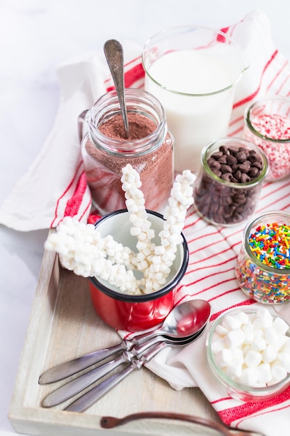 Hot chocolate bar with variety of topping on the tray .