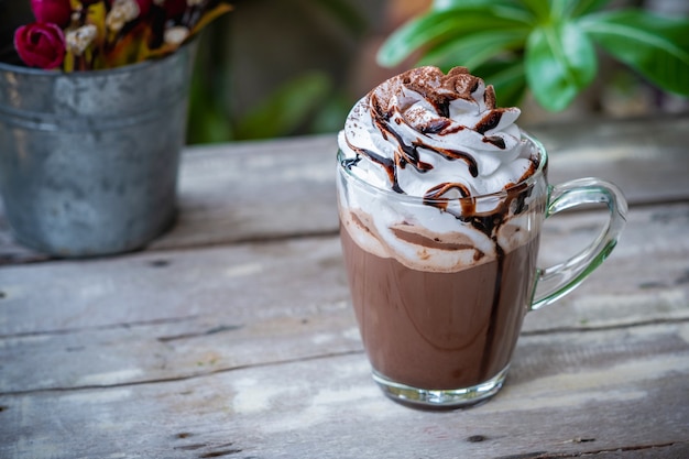 Hot chocolate cocoa in glass mug with whipped cream 