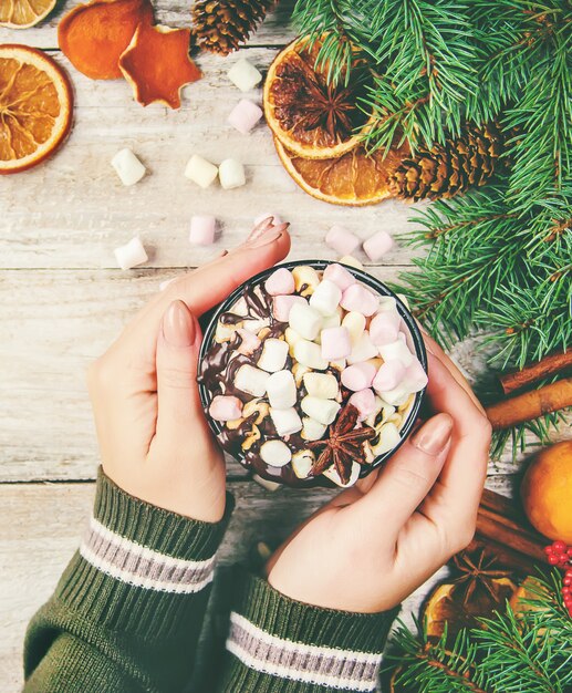 Hot chocolate and marshmallow on christmas background. Selective focus.