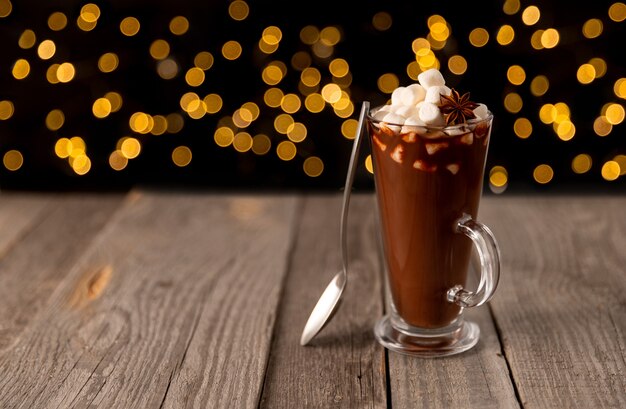 Hot chocolate with marshmallow on wooden table with copy space. Christams winter hot drink menu recipe