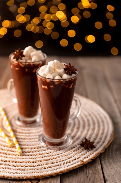 Hot chocolate with marshmallow on wooden table with copy space