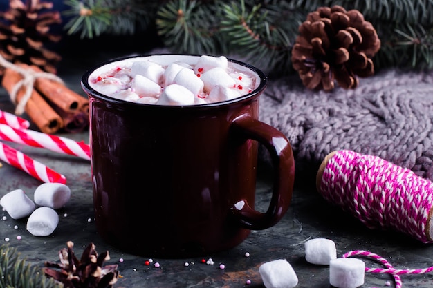 Hot Chocolate with Marshmallows in a Ceramic Cup on table. Festive decoration. Xmas concept.