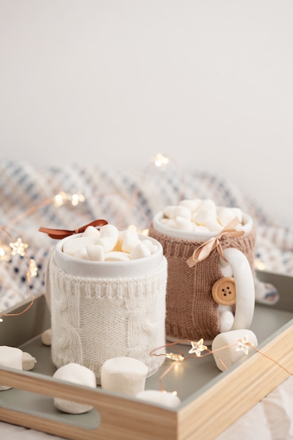 Hot chocolate with marshmallows on soft plaid 