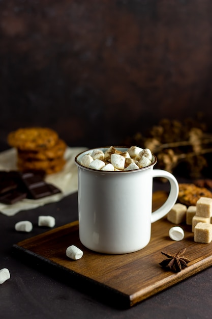 Hot chocolate with marshmallows in a white mug on a rusty