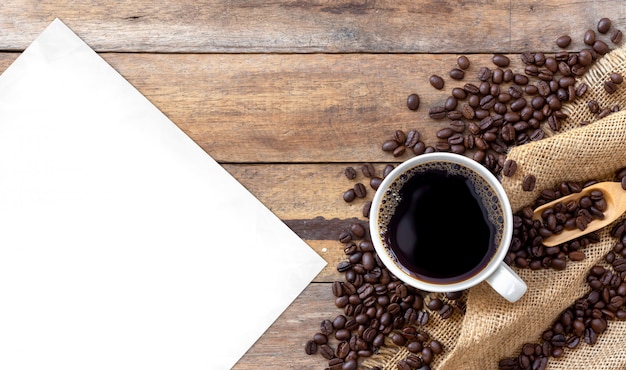 Hot coffee and bean on wooden background. top view