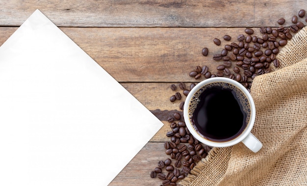 Hot coffee and bean on wooden background. top view