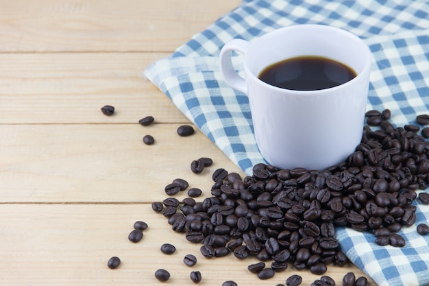 hot coffee and coffee bean on napkin plaid blue and white