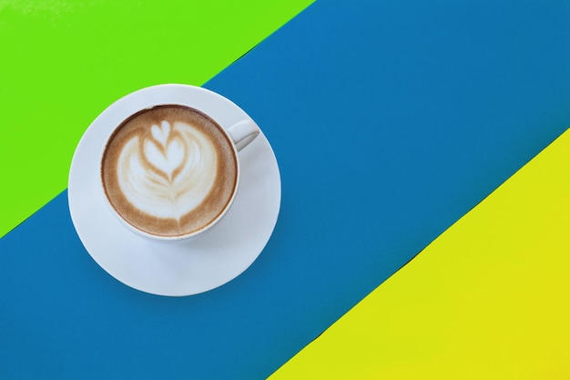 Hot coffee cup on multi color background