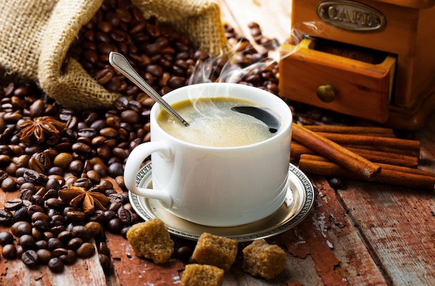 Hot coffee in a cup on an old background