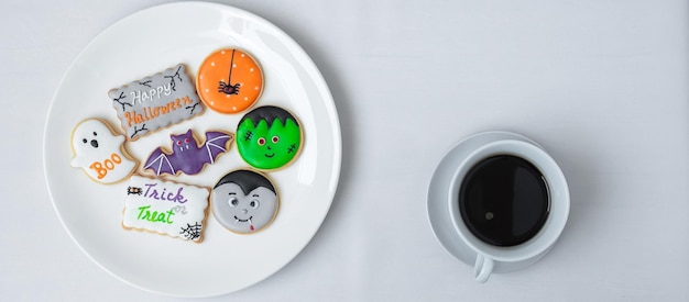 Hot coffee cup with funny Halloween Cookies Happy Halloween day Trick or Threat Hello October fall autumn Traditional party and holiday concept