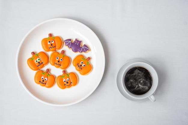 Hot coffee cup with funny Halloween Cookies Happy Halloween day Trick or Threat Hello October fall autumn Traditional party and holiday concept