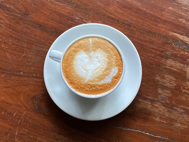 Hot coffee cup with heart latte art