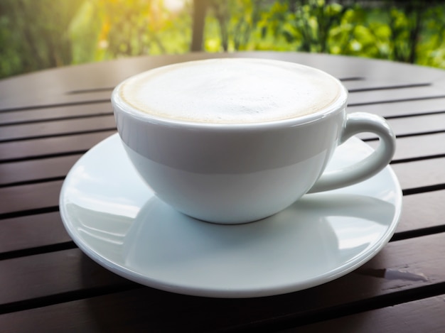 Hot Coffee cup on wooden table.