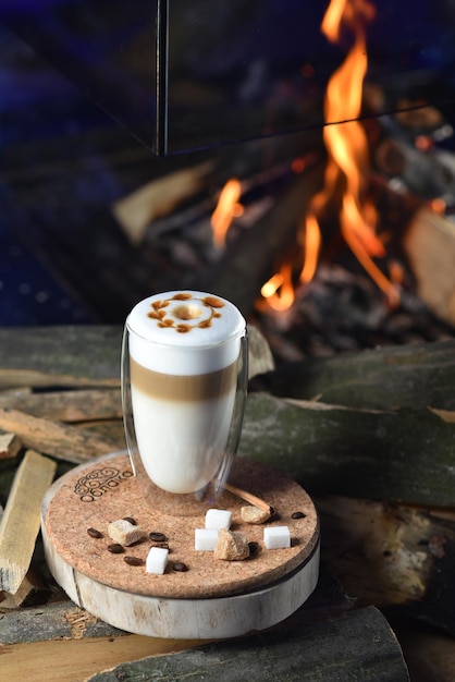 Hot coffee drink Latte Macchiato on fire background