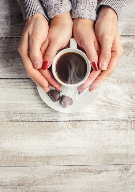 Hot coffee in the hands of a loved one.