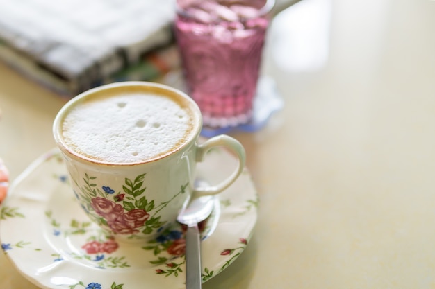 Hot coffee, latte and cold water with newspapers